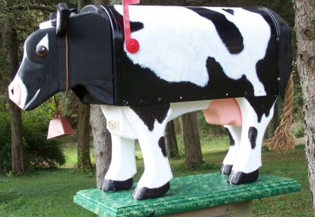 A cow mailbox - black, cow, white, red, green, mailbox