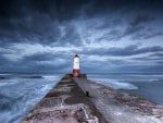 lighthouse at the end of a stone pier