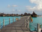 a pier to a bungalow resort in paradise