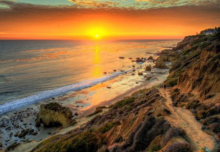 Sunset over the Sea - cliff, ocean, reflection, rocks, sun, sky