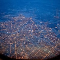 city grid in lights from an airplane window