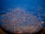 city grid in lights from an airplane window