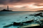 lighthouse on an island in a misty sea