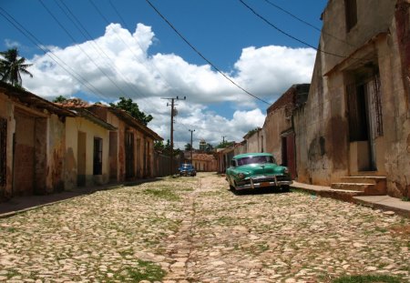 old cars on a street in a cuban town - street, town, cars, clouds