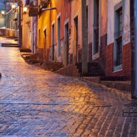 an uphill alley wet after rain