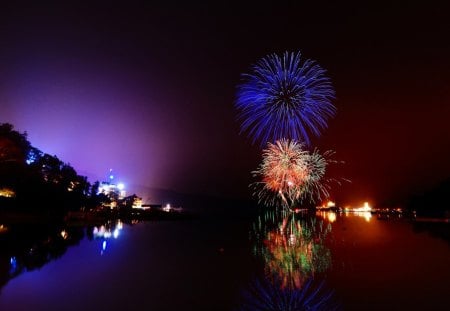 colorful fireworks above a river in pitch black - river, shore, lights, colors, fireworks, dark