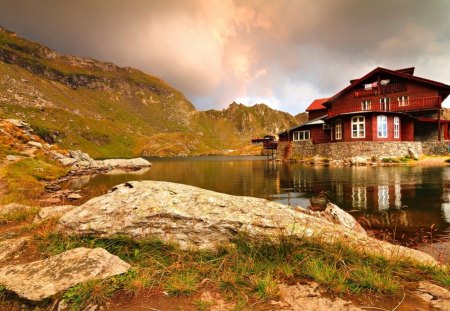 Lakeshore cabin - pretty, lonely, cabin, amazing, grass, reflection, mountain, shore, lake, nice, cottage, sky, clouds, house, water, beautiful, lovely, stones, lakeshore, nature, rays, rocks