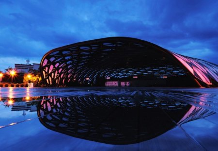 cavernous hanger after a storm - hanger, lights, wet, night, tarmac