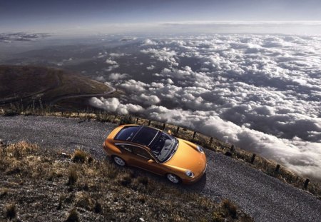 porsche carrera gt climbing a mountain - road, clouds, maountain, car