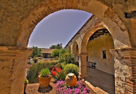 Spanish Home - stone, blue, tan, orange, architecture, home, flowers, spanish, nature, purple, ancient, sky