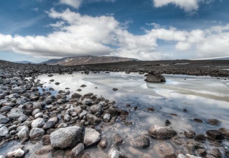 pools of water on a rocky plain - clouds, pools, plain, mountain, rocks