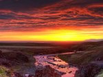 loud sunset reflected in a river