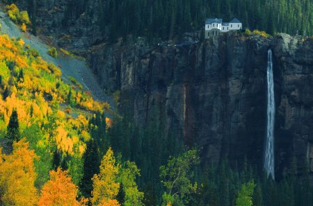 house above a tall waterfall - house, waterfall, autumn, cliff, forest, tall