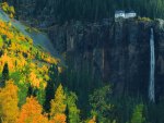 house above a tall waterfall