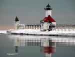 dual lighthouses on an icy pier