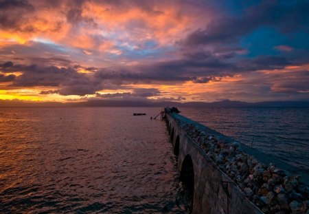 gorgeous sunset over a rocky pier - pier, clouds, sunset, sea, rocks