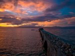 gorgeous sunset over a rocky pier