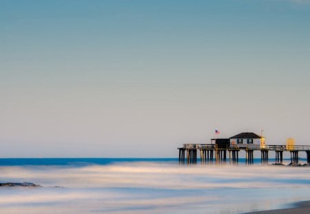 lovely pier over a misty sea - beach, flag, pier, sea, hut, mist