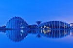 modern buildings reflected in lake