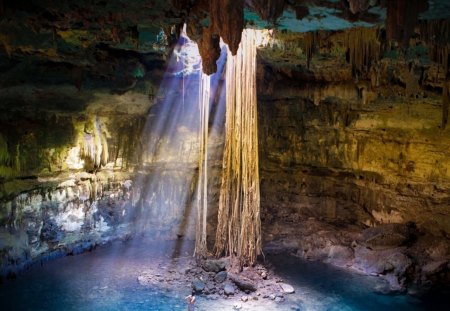 sunbeams into a large cave - cave, pool, sunbeams, roots, girl