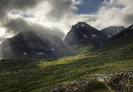 sunbeams through low mountain clouds - clouds, slopes, sunbeams, grass, mountains