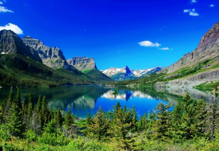 Saint Mary lake - nice, sky, trees, greenery, round, quiet, reflection, calmness, pretty, clouds, glacier national park, lake, saint mary, mountain, summer, shore, lovely, serenity, blue, beautiful, silence