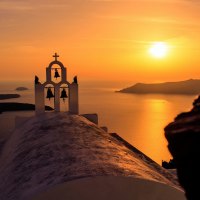 sunset over a church on a greek isle