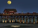 moon over tiki bar on a pier