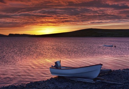 sunset over a sea in ripples - boats, shore, sunset, sea, ripples