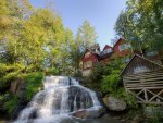 beautiful waterfalls by a red house