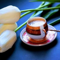 White tulips near cup of  coffee