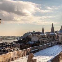 fortress overlooking a city in winter