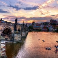 boat racing on a river in prague at sundown