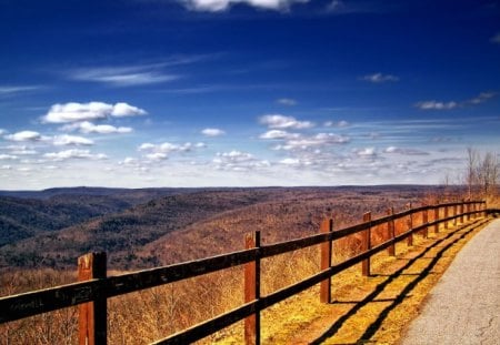 Fenced - country road, blue sky, hills, white clouds