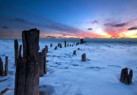 sunset over frozen sea - sea, winter, sunset, pylons