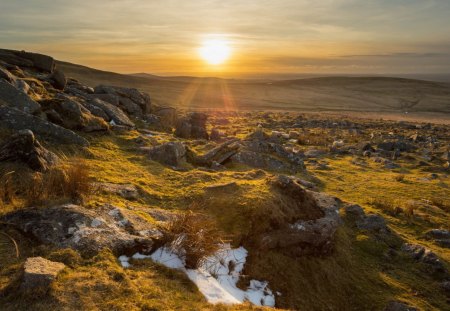 sundown over a rocky countryside - hills, sundown, rocks, fields