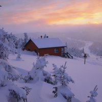 fantastic mountain cabin in a winter sunset