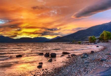 pebbled beach at sunset - clouds, sunset, beach, pebbles, sea, mountains, rocks