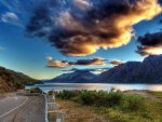 highway winding around a lake hdr