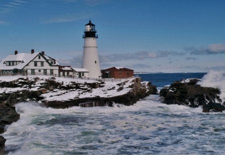 lighthouse on a rugged seacoast in winter - wnter, coast, lighthouse, rugged, sea, rocks