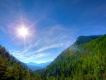 sunshine over forests in a valley hdr