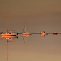 boats on mirrored harbor