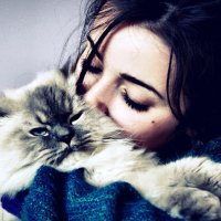 Girl hugs and kisses kitten