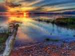 sunset on a serene bay shore hdr