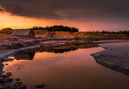 reflection on a calm river - clouds, river, shore, sunset, huts, reflection