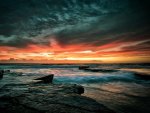 dark sunset on a rocky seashore