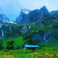 fantastic mountain waterfalls down to a green valley