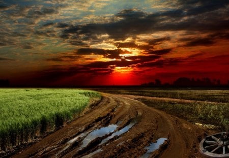 glorious sunset over wagon wheel by side of road - fields, clouds, sunset, wheel, road