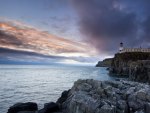 lighthouse atop seacoast cliffs