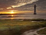 beautiful lighthouse off shore at sunrise